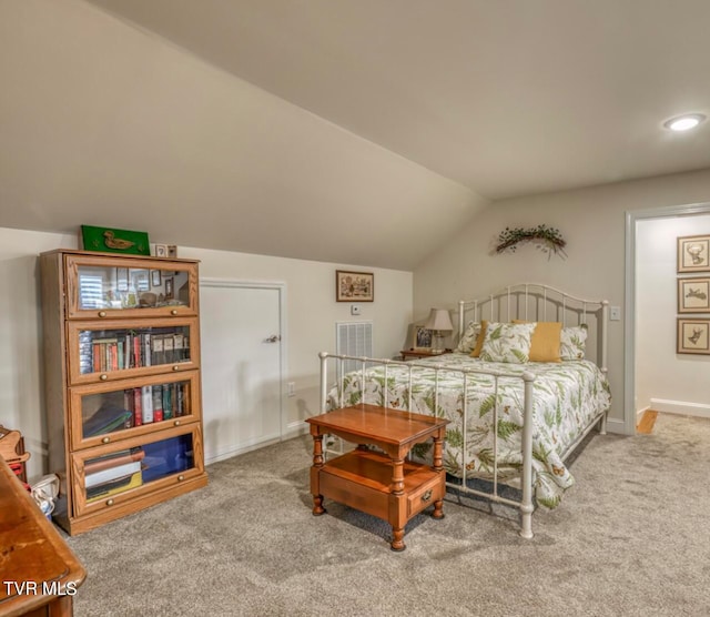 bedroom with carpet flooring and lofted ceiling