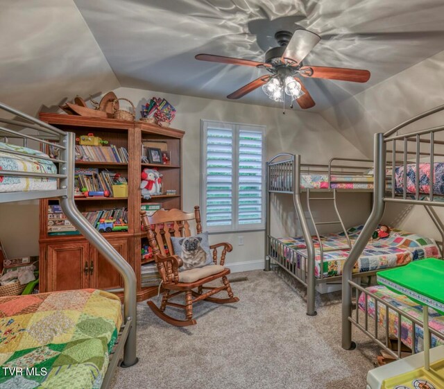 carpeted bedroom featuring ceiling fan and vaulted ceiling