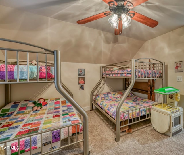 carpeted bedroom featuring ceiling fan and lofted ceiling