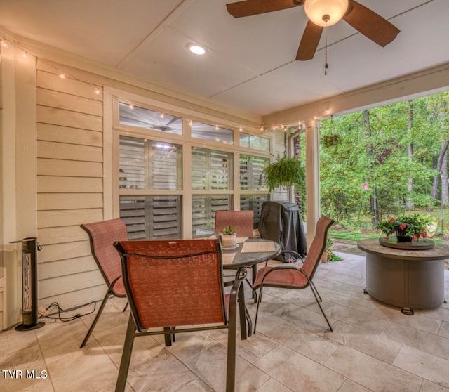 sunroom / solarium featuring a wealth of natural light and ceiling fan