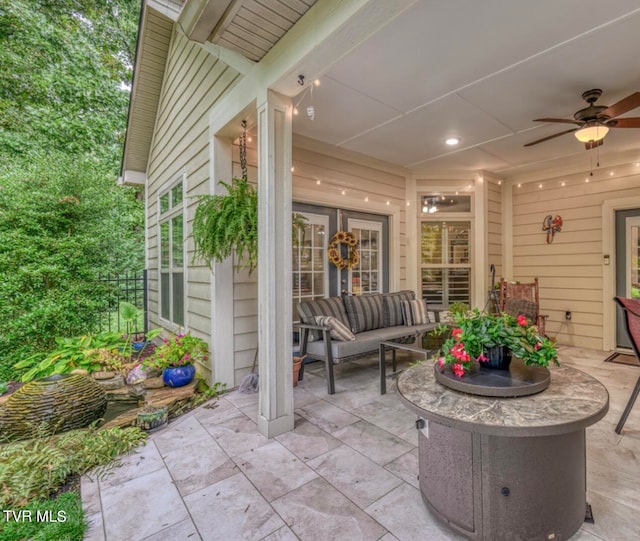 view of patio with outdoor lounge area and ceiling fan