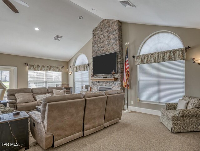 living room featuring ceiling fan, light colored carpet, lofted ceiling, and a fireplace