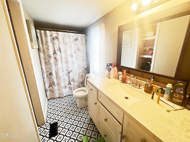 bathroom with curtained shower, vanity, and toilet