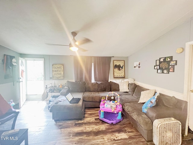 living room featuring ceiling fan and hardwood / wood-style flooring