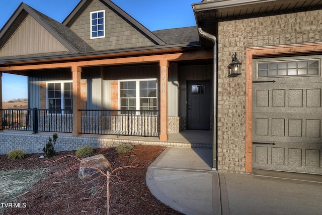 entrance to property with a garage and a porch