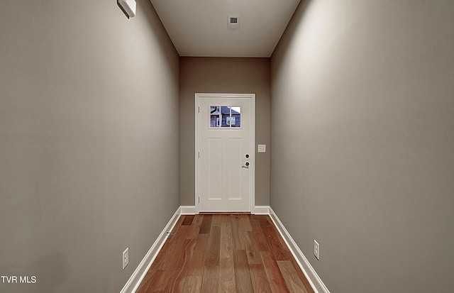 doorway to outside featuring wood-type flooring