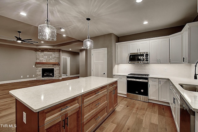 kitchen with a kitchen island, white cabinets, and appliances with stainless steel finishes