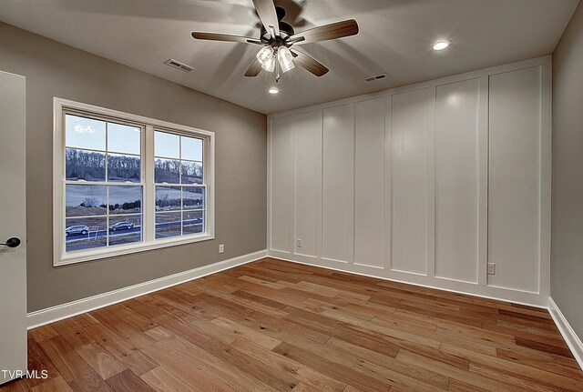 unfurnished room featuring ceiling fan and light wood-type flooring