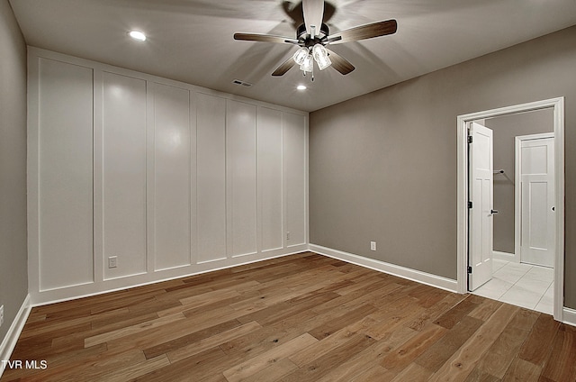 spare room featuring light hardwood / wood-style floors and ceiling fan