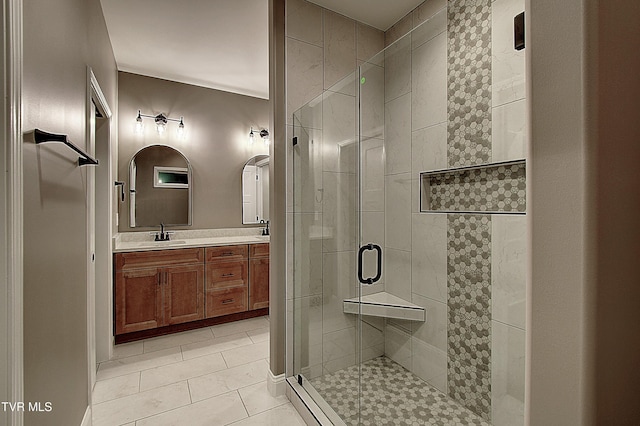 bathroom featuring vanity, tile patterned flooring, and a shower with shower door