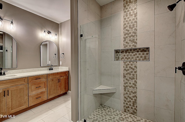 bathroom with vanity and a tile shower