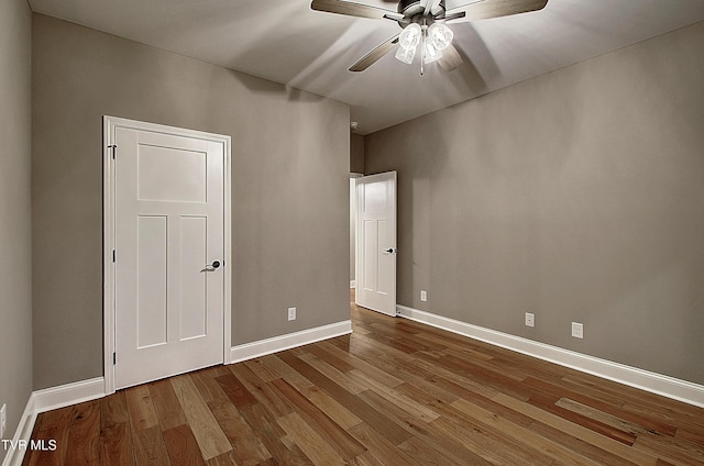 unfurnished bedroom featuring hardwood / wood-style flooring and ceiling fan