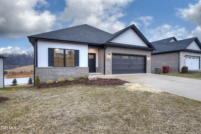 view of front of property with central AC and a garage