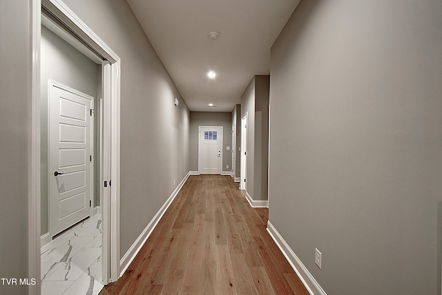 corridor with light hardwood / wood-style flooring