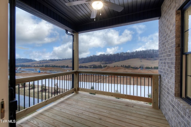 wooden terrace featuring ceiling fan and a rural view