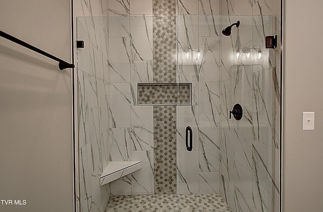 bathroom featuring a shower with shower door