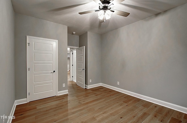 spare room featuring ceiling fan and light hardwood / wood-style floors