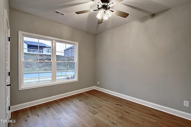 spare room featuring ceiling fan and light hardwood / wood-style flooring