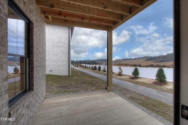 exterior space featuring a water view and a patio