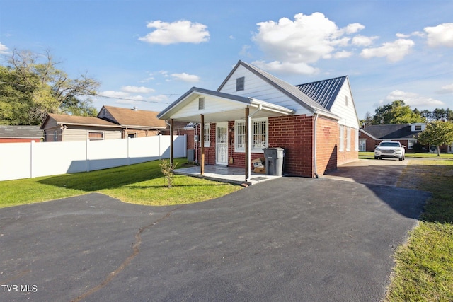 view of front of property with a front yard and covered porch