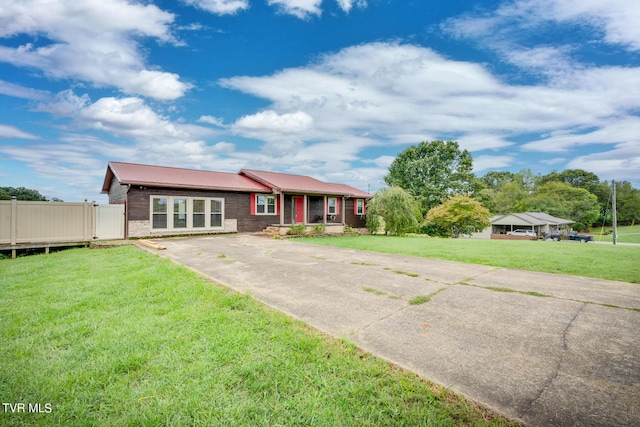 ranch-style home featuring a front yard