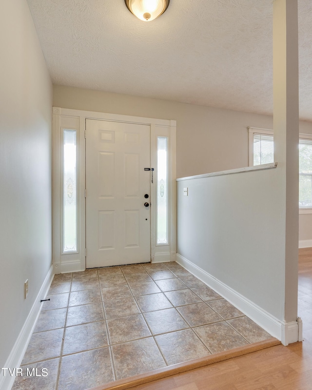 entryway featuring a textured ceiling and hardwood / wood-style flooring