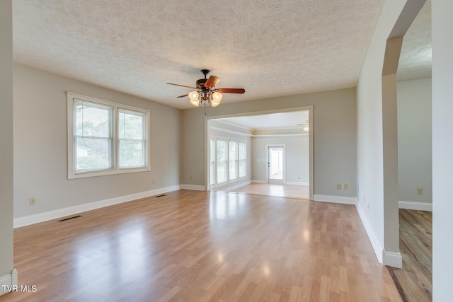 interior space with a textured ceiling, light hardwood / wood-style floors, and ceiling fan