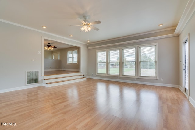 unfurnished living room featuring crown molding, ceiling fan, and light hardwood / wood-style flooring