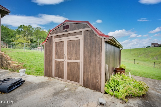 view of outbuilding with a lawn