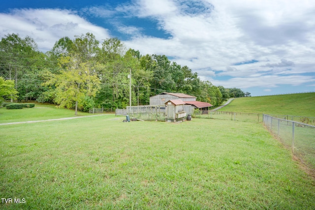 view of yard featuring an outbuilding and a rural view