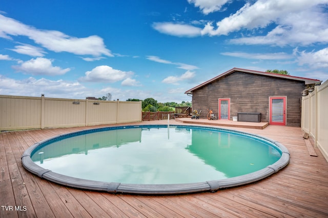 view of swimming pool with a wooden deck