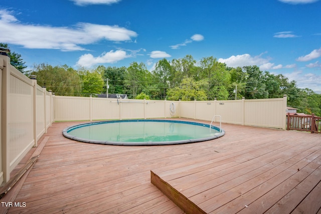 view of swimming pool with a wooden deck