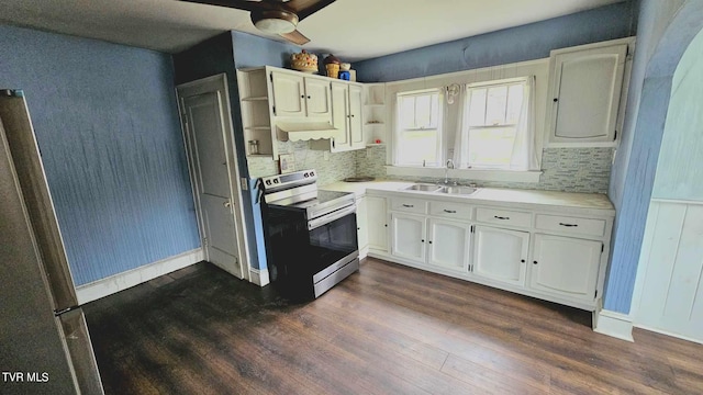 kitchen with appliances with stainless steel finishes, white cabinetry, dark wood-type flooring, ceiling fan, and sink