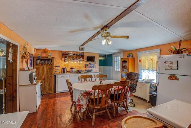 dining room featuring a textured ceiling, lofted ceiling with beams, ceiling fan, and hardwood / wood-style floors