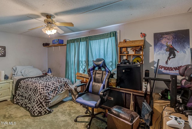 carpeted bedroom featuring a ceiling fan and a textured ceiling
