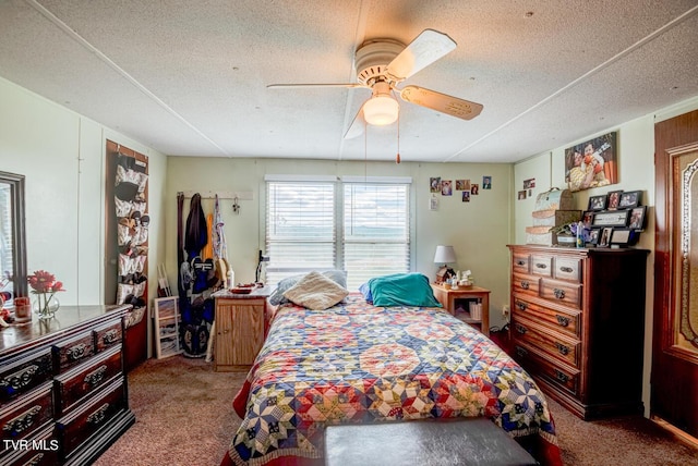 carpeted bedroom featuring a textured ceiling and a ceiling fan