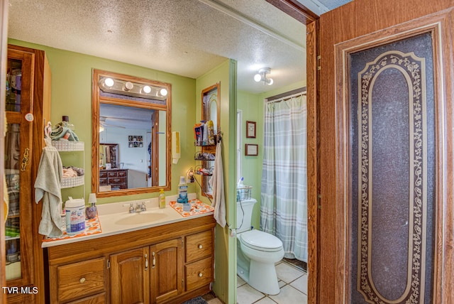 bathroom with vanity, curtained shower, a textured ceiling, tile patterned floors, and toilet