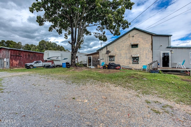 rear view of property featuring an outdoor structure