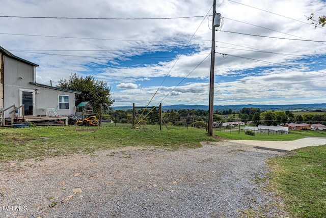 view of yard with a mountain view and fence