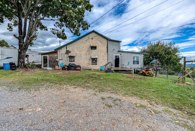 rear view of house with a yard