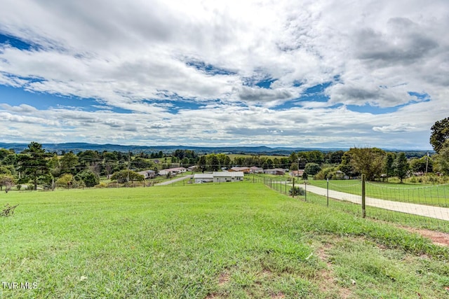 exterior space with a mountain view, fence, and a rural view
