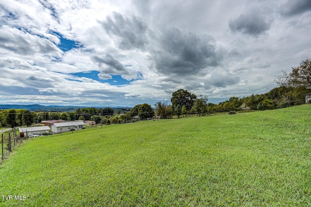 view of yard featuring fence and a rural view