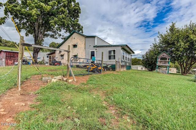 back of property featuring a yard