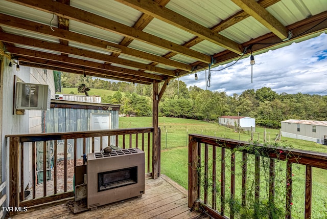 wooden deck with a lawn and a storage unit