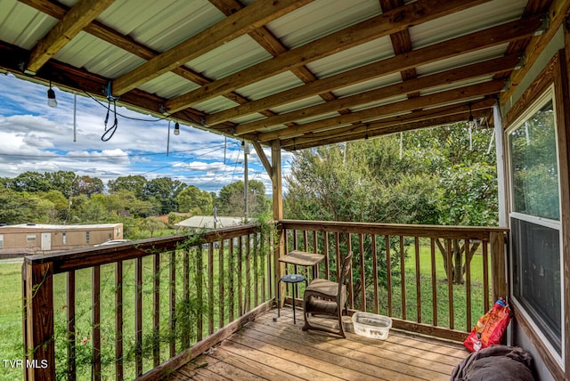 wooden deck featuring a yard