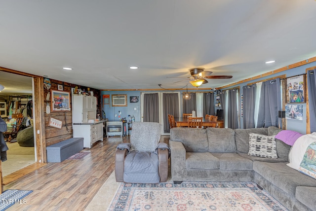 living room featuring ceiling fan and light hardwood / wood-style flooring