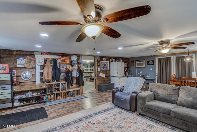 living area with a ceiling fan, recessed lighting, and wood finished floors