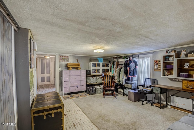carpeted office featuring a textured ceiling