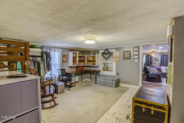 interior space with ornamental molding, carpet, baseboards, and a textured ceiling