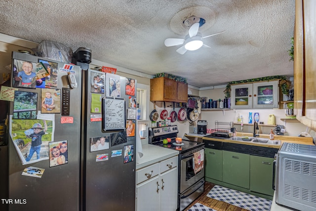 kitchen with ceiling fan, sink, a textured ceiling, stainless steel appliances, and hardwood / wood-style floors